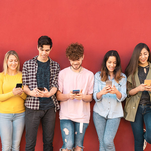 Group Young Friends Using Mobile Smartphone Outdoor - Millennial Group young friends using mobile smartphone outdoor - Millennial generation having fun with new trends social media apps - Youth technology people addicted - Red background